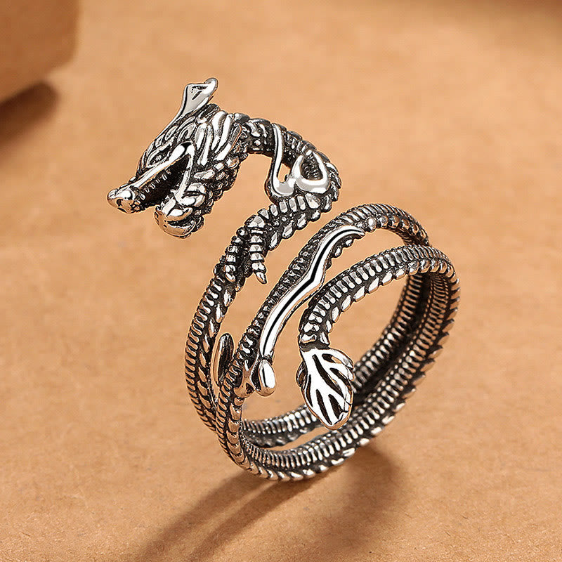 Vintage Dragon Pattern Copper Ring - Side profile of coiled dragon ring on kraft, fierce