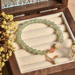 Hetian Jade Gourd Lotus Bracelet resting in antique wooden jewelry box with dried flowers, heritage luck gift