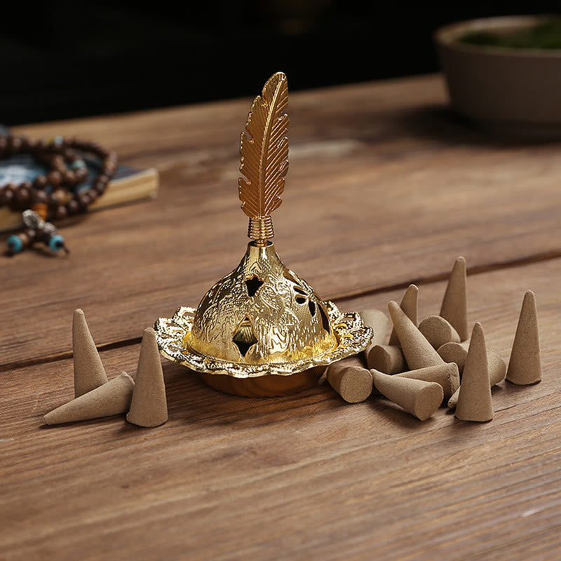 Mini Alloy Incense Burner – gold dome burner with feather finial surrounded by incense cones on wood