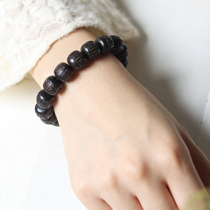 Ebony Wood Mantra Bracelet – Wrist close-up with light sleeve showing worn look, bead bracelet