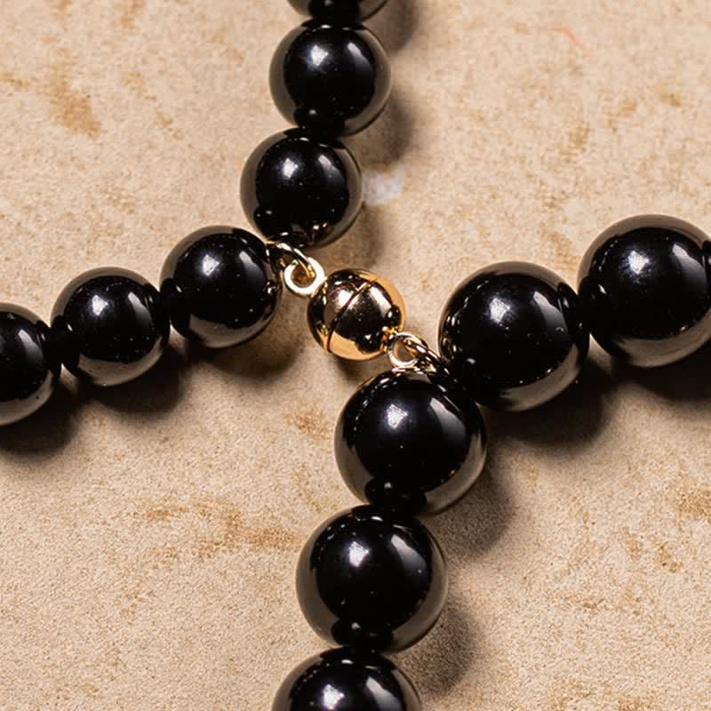 Black Obsidian Jade Bracelet – Detail of gold ornamental connector bead linking black obsidian strands
