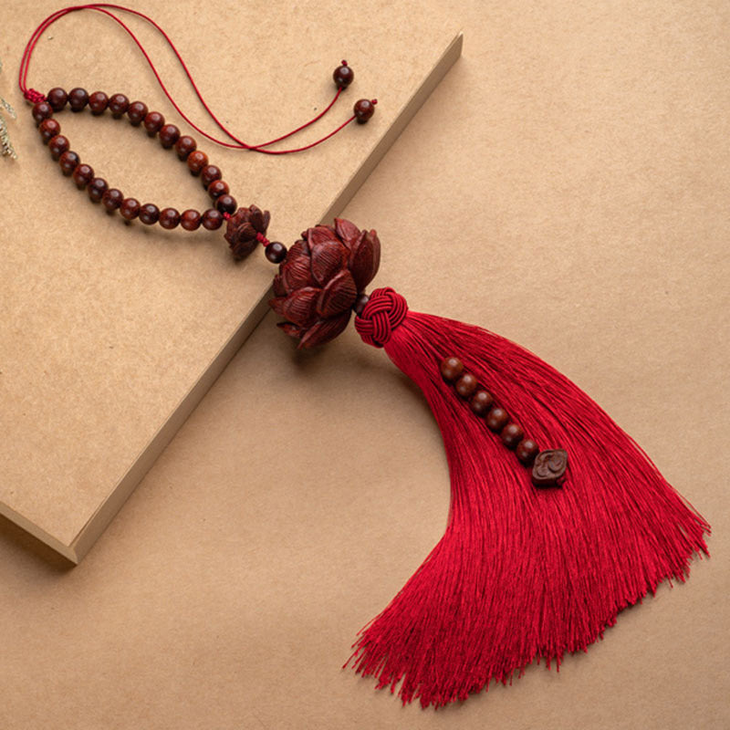 Red Sandalwood Lotus Tassel - red tassel with beaded strand and book, warm artisan styling