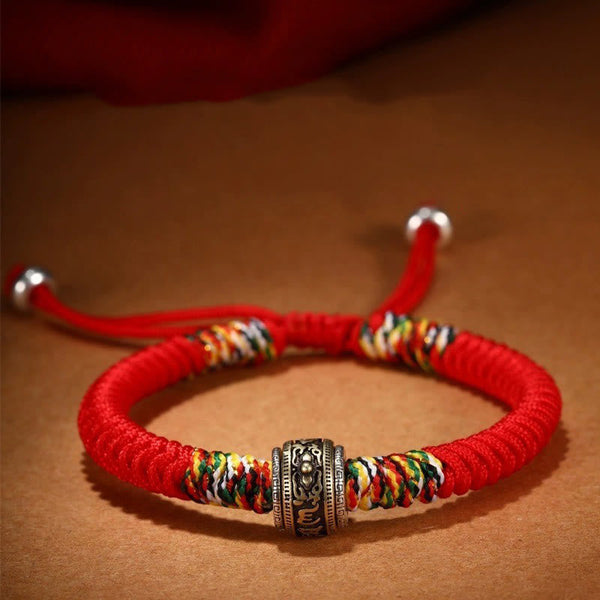 Tibetan Mantra Bracelet – Red cord with prayer wheel bead and five-color knots, spiritual protection