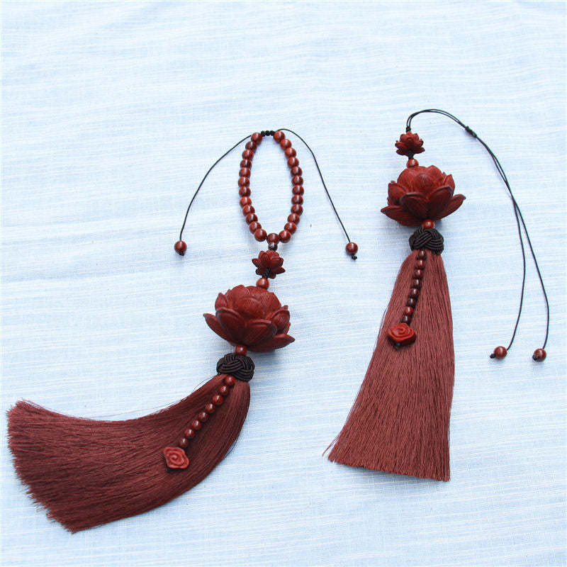 Red Sandalwood Lotus Tassel - curved vs straight tassel on pale fabric, two variants