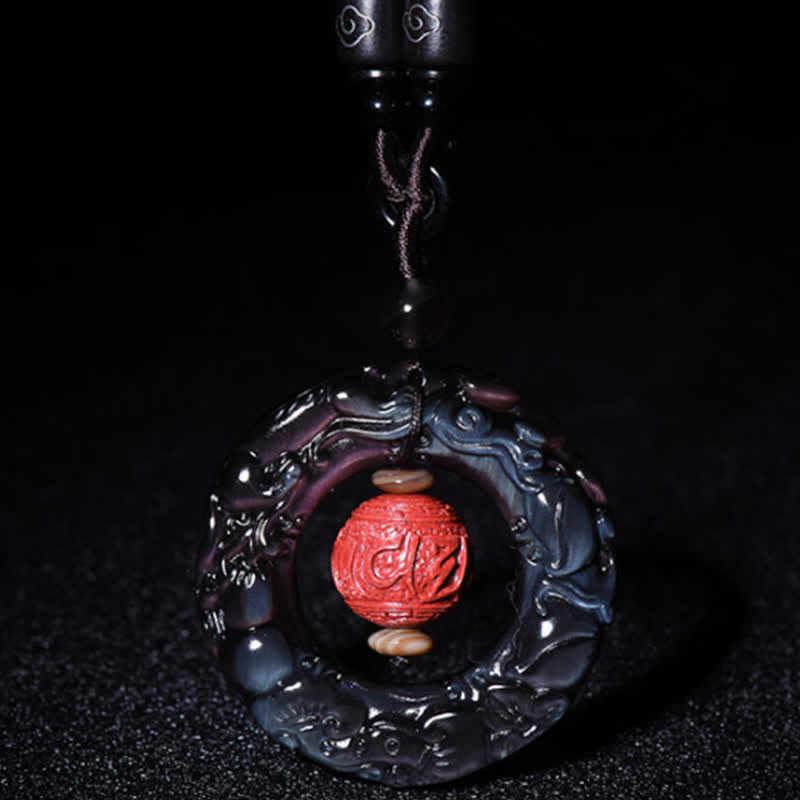 Rainbow Obsidian PiXiu Pendant – Rainbow obsidian pendant with red cinnabar bead on dark bg