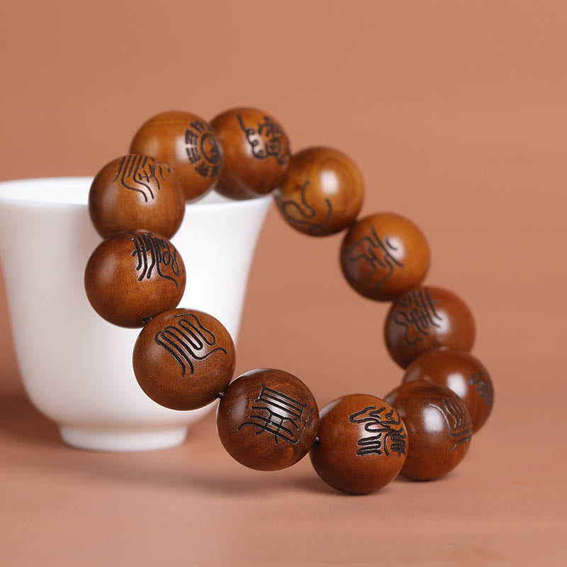 Lightning Struck Jujube Wood Taoist Scripture Bracelet - Wood bead bracelet draped over white ceramic cup, meditation wrist mala
