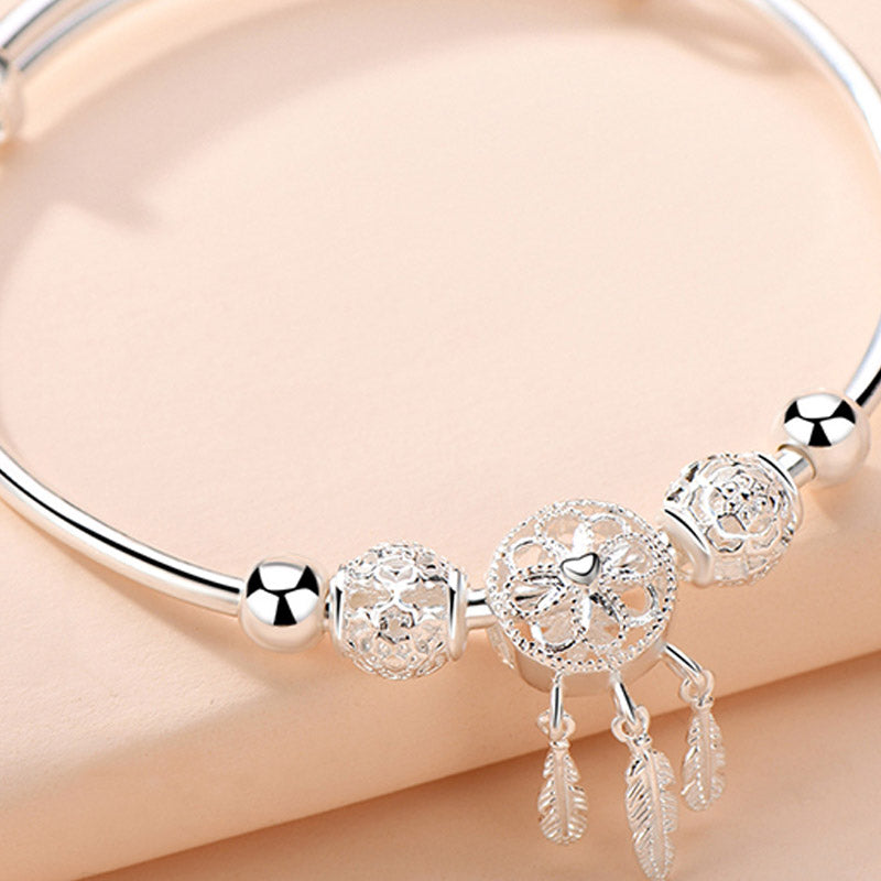 Dream Catcher Blessing Bracelet – Macro of filigree dreamcatcher bead with heart center on peach, close-up charm