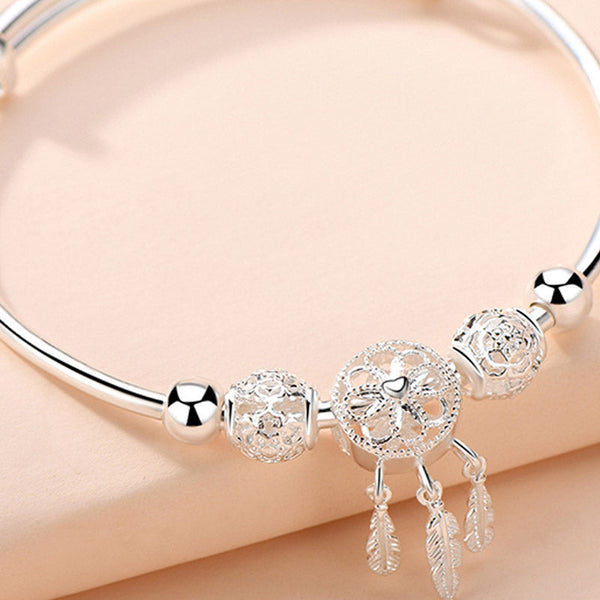 Dream Catcher Blessing Bracelet – Macro of filigree dreamcatcher bead with heart center on peach, close-up charm