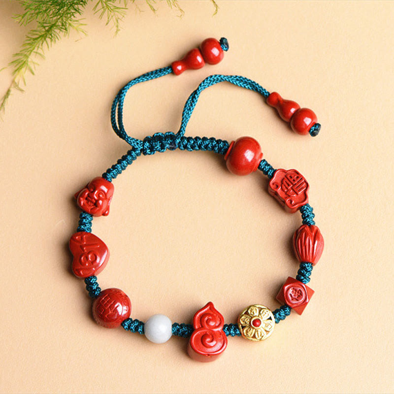 Cinnabar Laughing Buddha Bracelet – top-down flat lay red cinnabar beads and mantra engraving detail