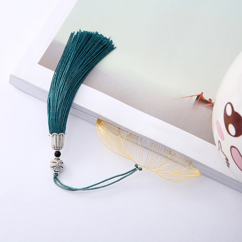 Lotus Brass Hollow Bookmark - golden lotus tucked in book with flowing tassel, refined reading