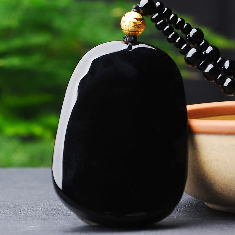 18K Gold Dragon Obsidian Lucky Pendant Necklace – Smooth black obsidian pebble with gold accent bead, serene