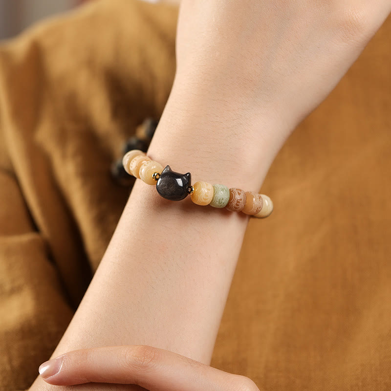 Bodhi Seed Cat Head Bracelet – Worn on wrist showing black obsidian cat charm with natural stone beads, everyday spiritual jewelry
