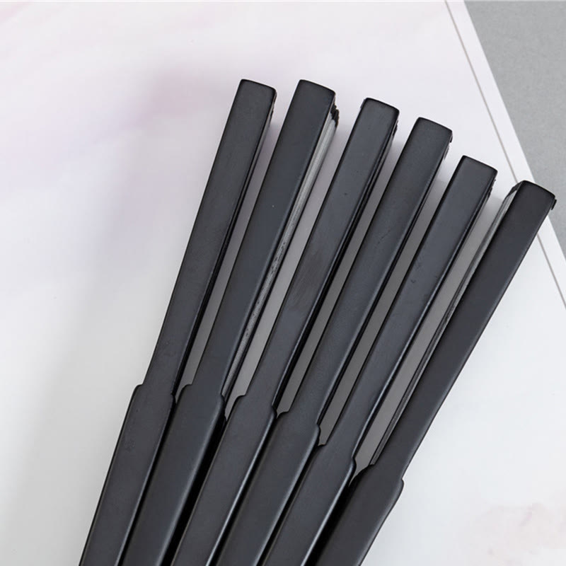 Fan Rib Macro – Extreme close-up of perforated lattice on black folding fan ribs, bamboo hand fan