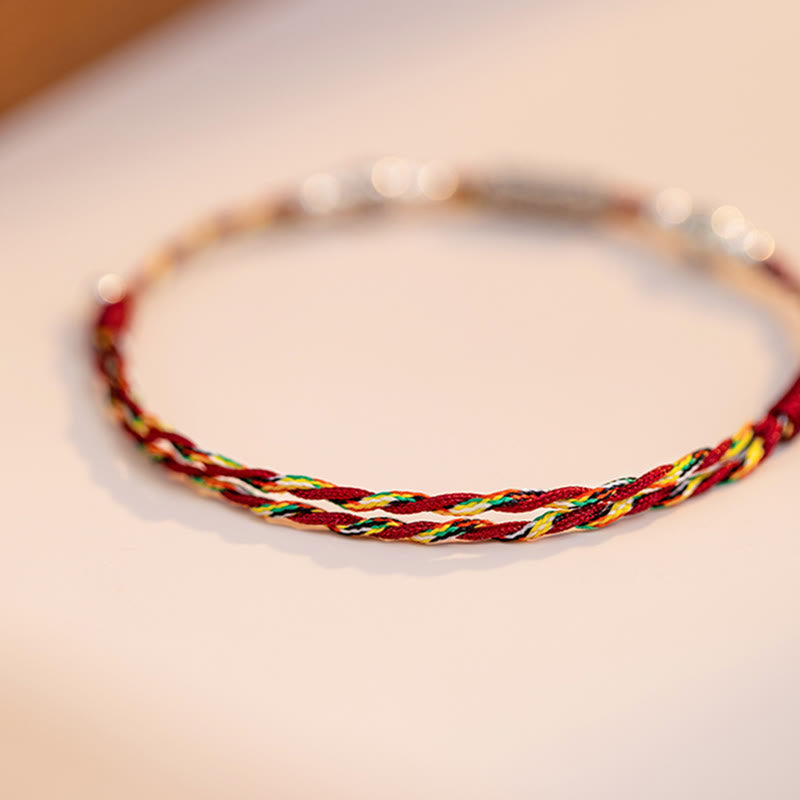 925 Koi Braided Bracelet - side profile of silver koi pendant on multi-color braid