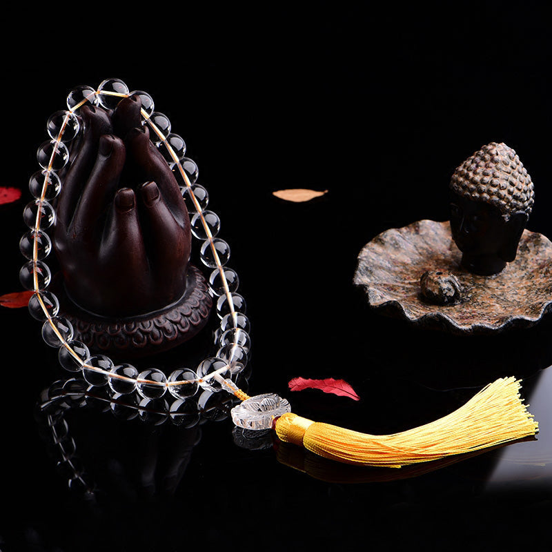 White Crystal Lotus Mala – crystal beads draped on Buddha hand sculpture with golden tassel, spiritual jewelry