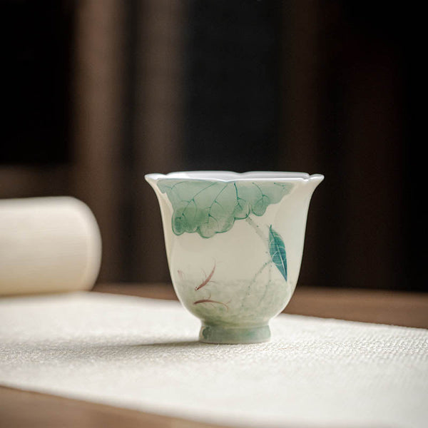 Koi Lotus Teacup – Side view showing swimming koi among lotus leaves, tea cup