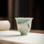 Koi Lotus Teacup – Side view showing swimming koi among lotus leaves, tea cup