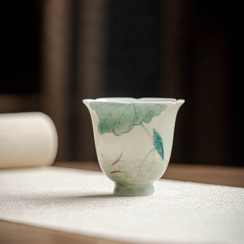 Koi Lotus Teacup – Side view showing swimming koi among lotus leaves, tea cup