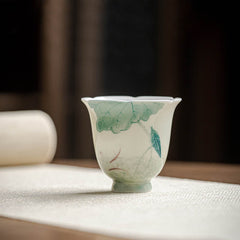 Koi Lotus Teacup – Side view showing swimming koi among lotus leaves, tea cup
