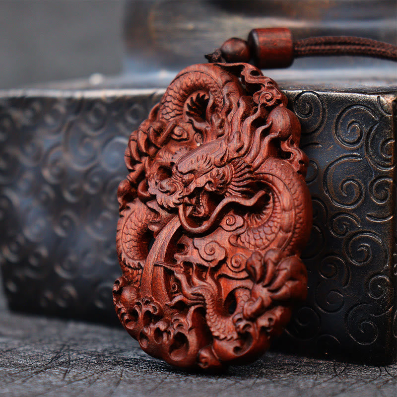 Lightning Jujube Wood Dragon Pendant - Low angle of coiled dragon relief with ornate box prop, Craftsmanship