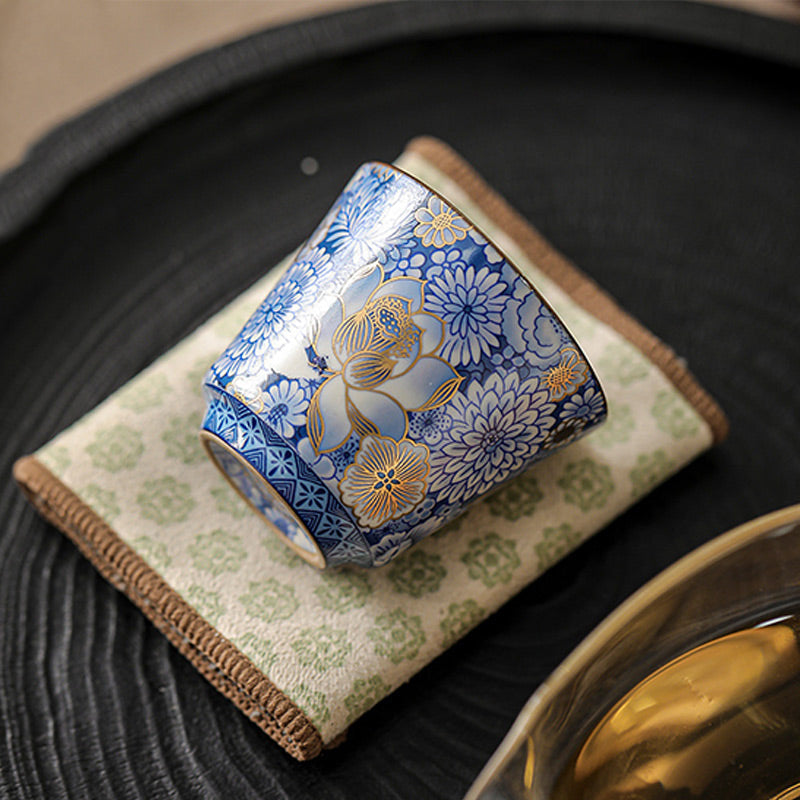 Lotus Chrysanthemum Ceramic Tea Cup - Cup resting on side showing full blue floral pattern, decorative