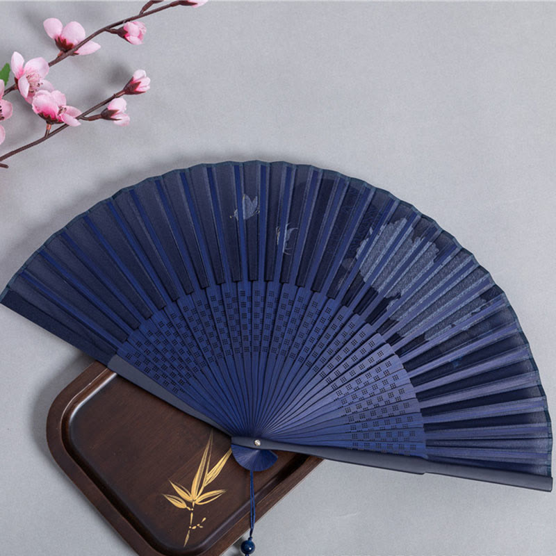 Plum Blossom Folding Fan – Navy fan with gold plum branch on decorative card with blossoms, silk fan