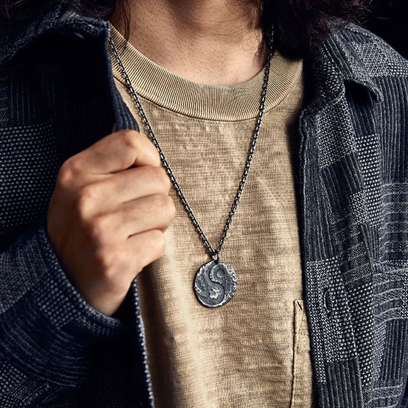 Sterling Silver Yin Yang Necklace – On-model shot, oxidized silver pendant with beige shirt and indigo jacket