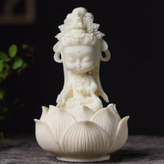 Kwan Yin Ivory Fruit Lotus Decoration - ivory-white chibi Guanyin on carved lotus base, dark background, Serene