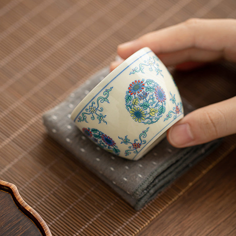 Koi Arowana Peony Cup – with tea poured showing color against white interior, tea