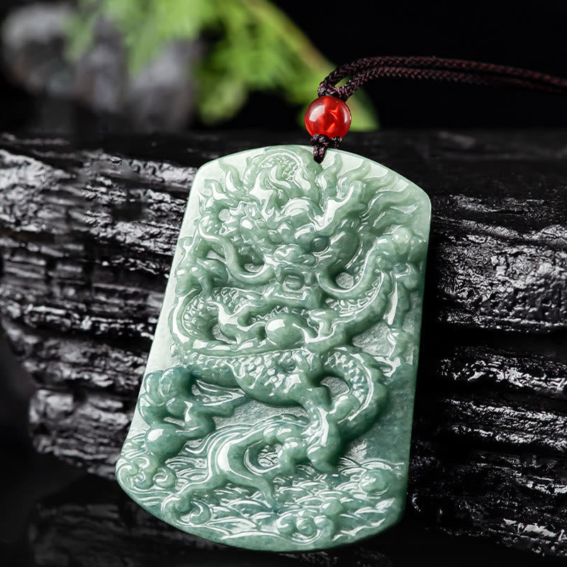 Natural Jade Dragon Pendant – Green jade dragon carving on weathered wood with foliage bokeh, Earthy origin