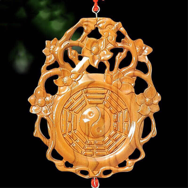 Peach Wood Bagua Map - Close-up on dark background, bagua yin yang wood ornament
