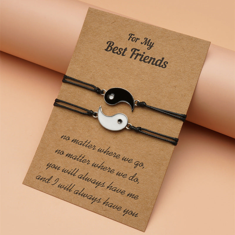 Yin Yang Hematite Bracelet - Black cord pair on kraft card with promise quote, angled view