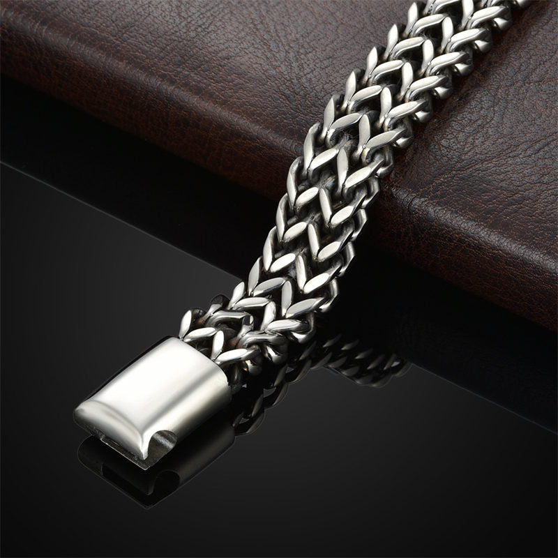 Fish Scale Titanium Steel Magnetic Bracelet – double Cuban link chain on brown leather, box clasp detail, dramatic lighting
