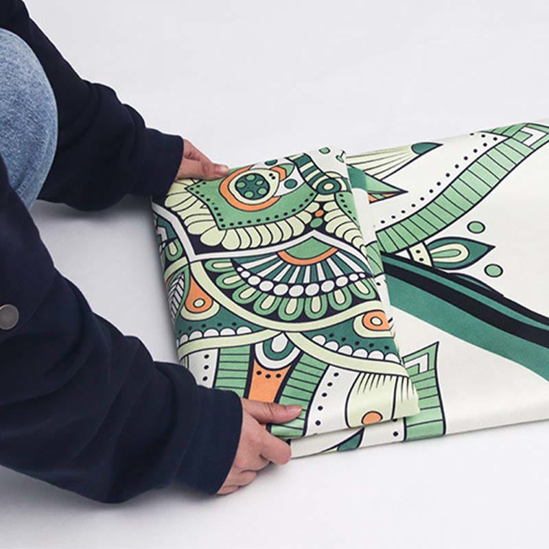 Tibetan Lotus Mandala Yoga Mat held vertically, green floral mandala pattern with sage and terracotta, zen meditation decor