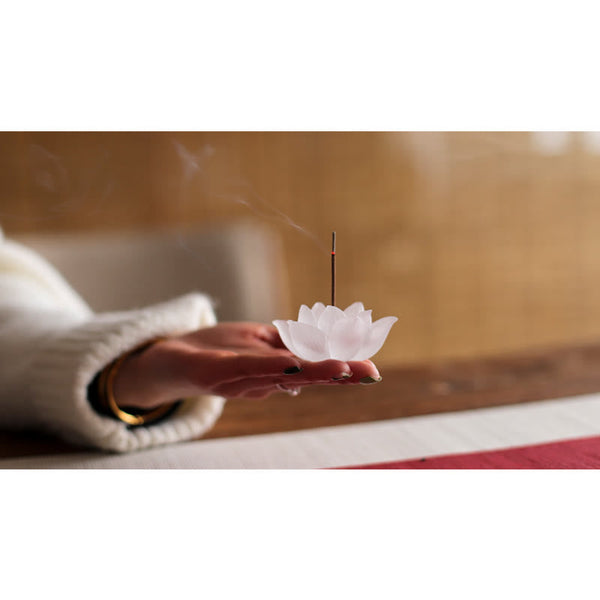 Lotus Liuli Incense Burner – held over red-edged mat with smoke, Warm