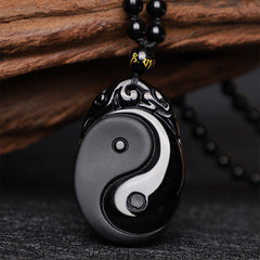 Black Obsidian Yin Yang Pendant Necklace – Carved obsidian Yin-Yang pendant with mantra beads, slate background