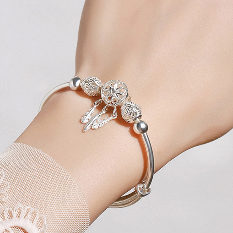 Dream Catcher Blessing Bracelet – Silver bangle worn on wrist with lace sleeve detail, on wrist jewelry