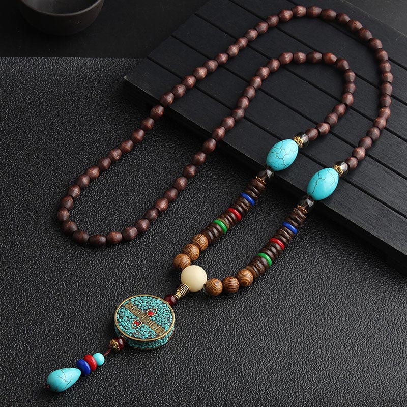 Turquoise Dzi Bead Prayer Wheel Wenge Wood Necklace - Long ethnic necklace with dark wood beads, turquoise oval stones, mosaic turquoise pendant, and colorful tassel