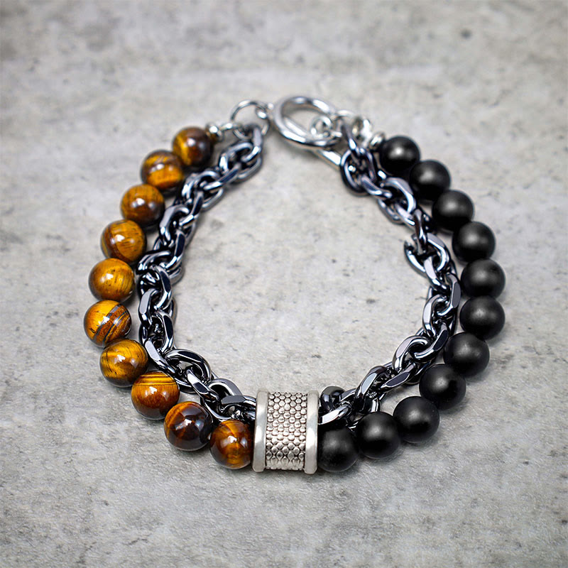 Tiger Eye Lazurite Malachite Protection Bracelet – Angled overhead shot of dual-strand men's bracelet combining golden tiger's eye, matte black beads, gunmetal chain, and honeycomb-textured spacer