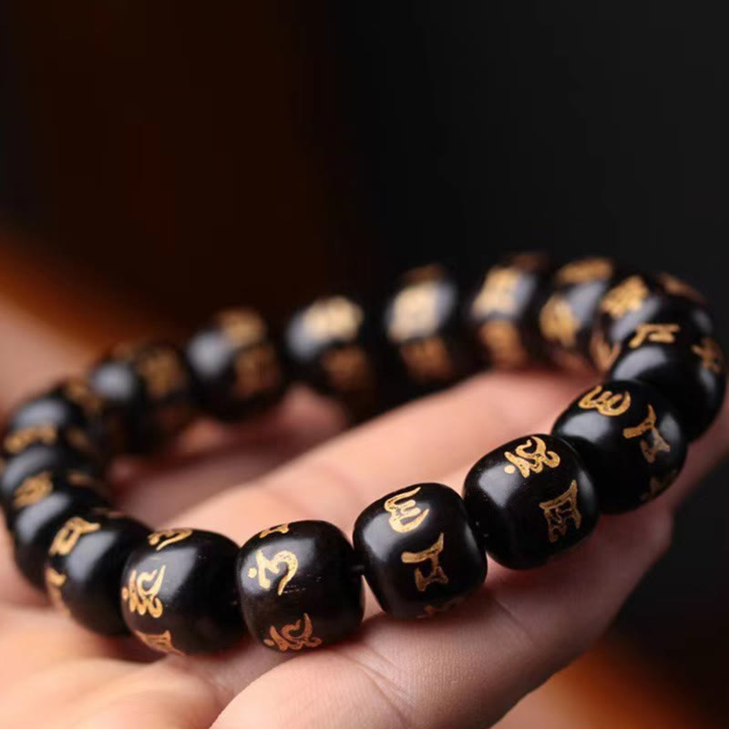 Ebony Wood Om Mani Padme Hum Bracelet – Resting across open palm with shallow depth of field, mala bracelet