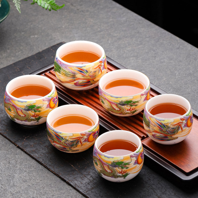 Dragon Phoenix Ceramic Teacup - Six-cup set on wooden tray filled with amber tea, traditional ceremony