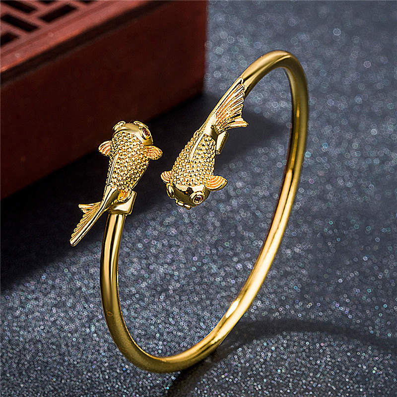 Double Koi Fish Copper Prosperity Bracelet – overhead view, circular koi motif detail