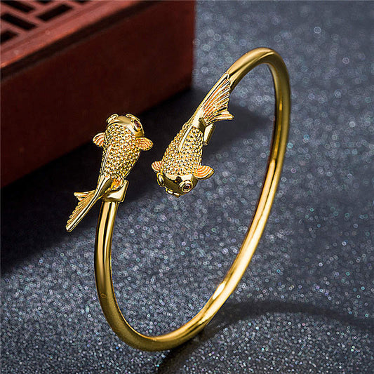 Double Koi Fish Copper Prosperity Bracelet – overhead view, circular koi motif detail