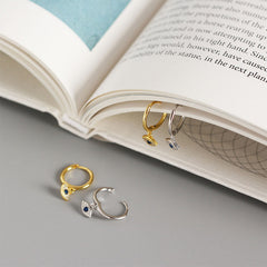 Evil Eye Huggie Hoop Earrings on Open Book with Blue Sapphire Center, Silver & Gold