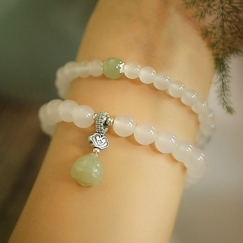 White Agate Jade Lotus Bracelet - Dual-strand with green jade drop on wrist, natural foliage, healing crystal