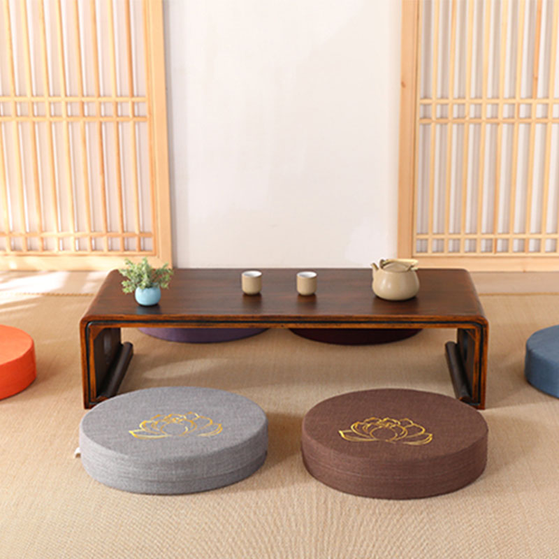 Lotus Meditation Cushion - Gray and brown zafu with wooden tea table, zen interior setup