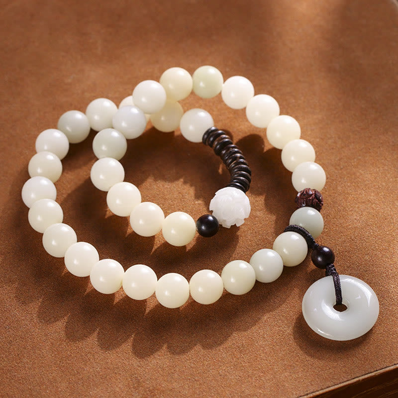 Bodhi Seed Sandalwood Lotus Bracelet - double-loop mala style on brown suede, lotus carved focal bead