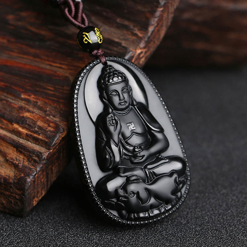 Chinese Zodiac Buddha Black Obsidian Necklace – crowned Buddha carving on polished obsidian with gold mantra bead, dark wood prop, spiritual guardian