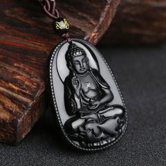 Chinese Zodiac Buddha Black Obsidian Necklace – crowned Buddha carving on polished obsidian with gold mantra bead, dark wood prop, spiritual guardian
