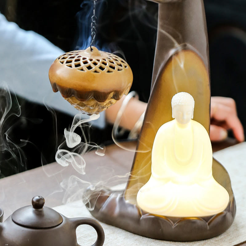 LED Buddha Hand Backflow Burner - lotus censer with teapot nearby in meditation room
